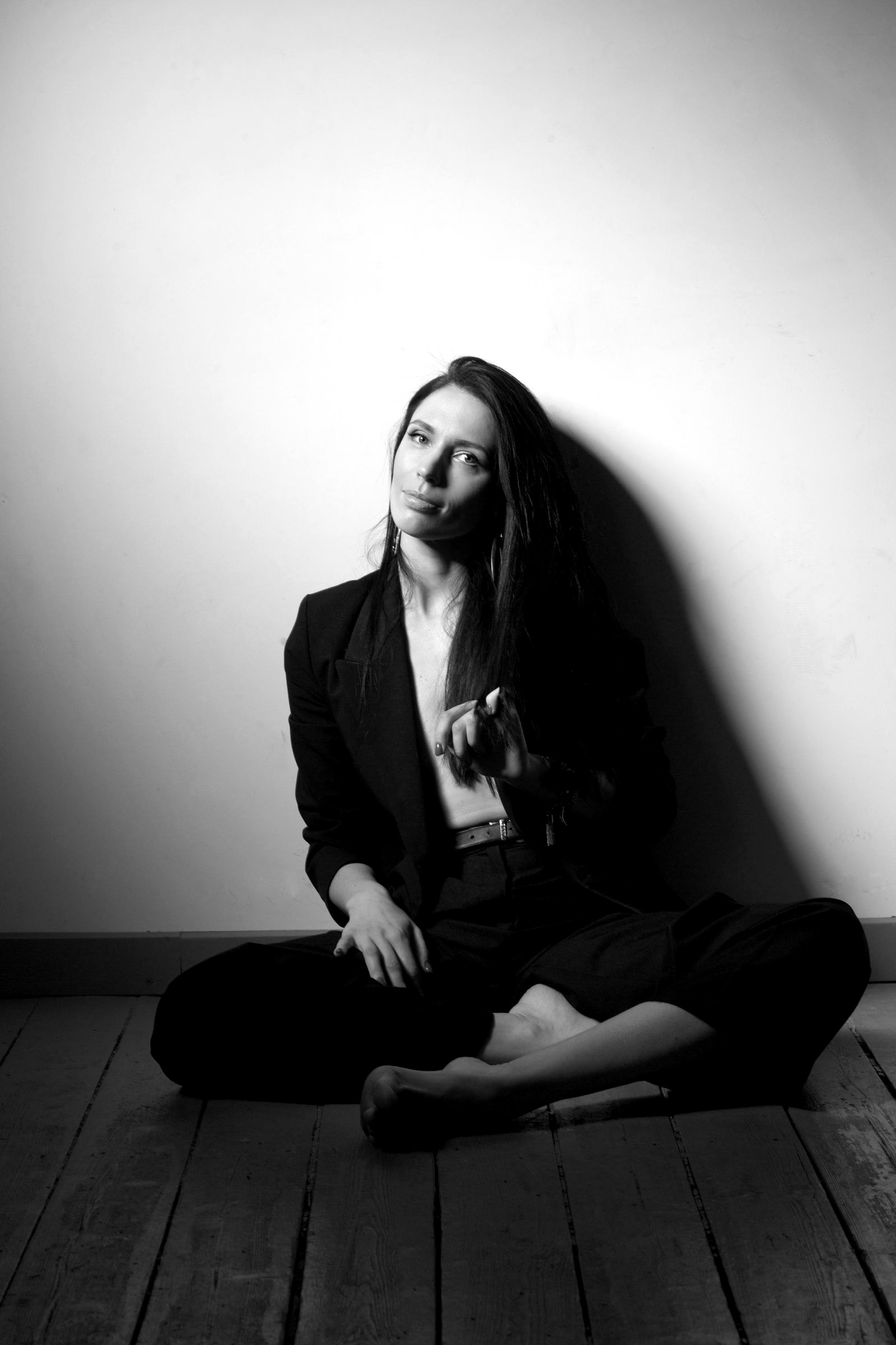 A guest seated for a studio portrait against a white backdrop
