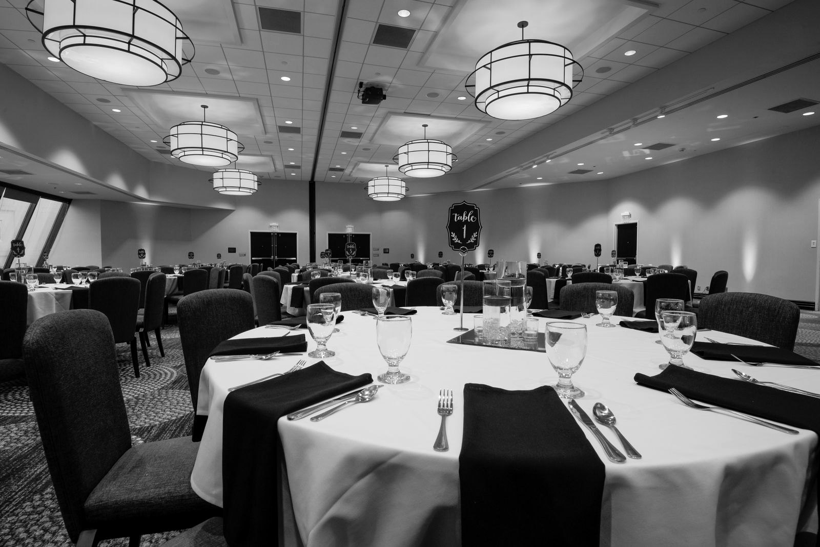 An elegant ballroom set for a corporate dinner