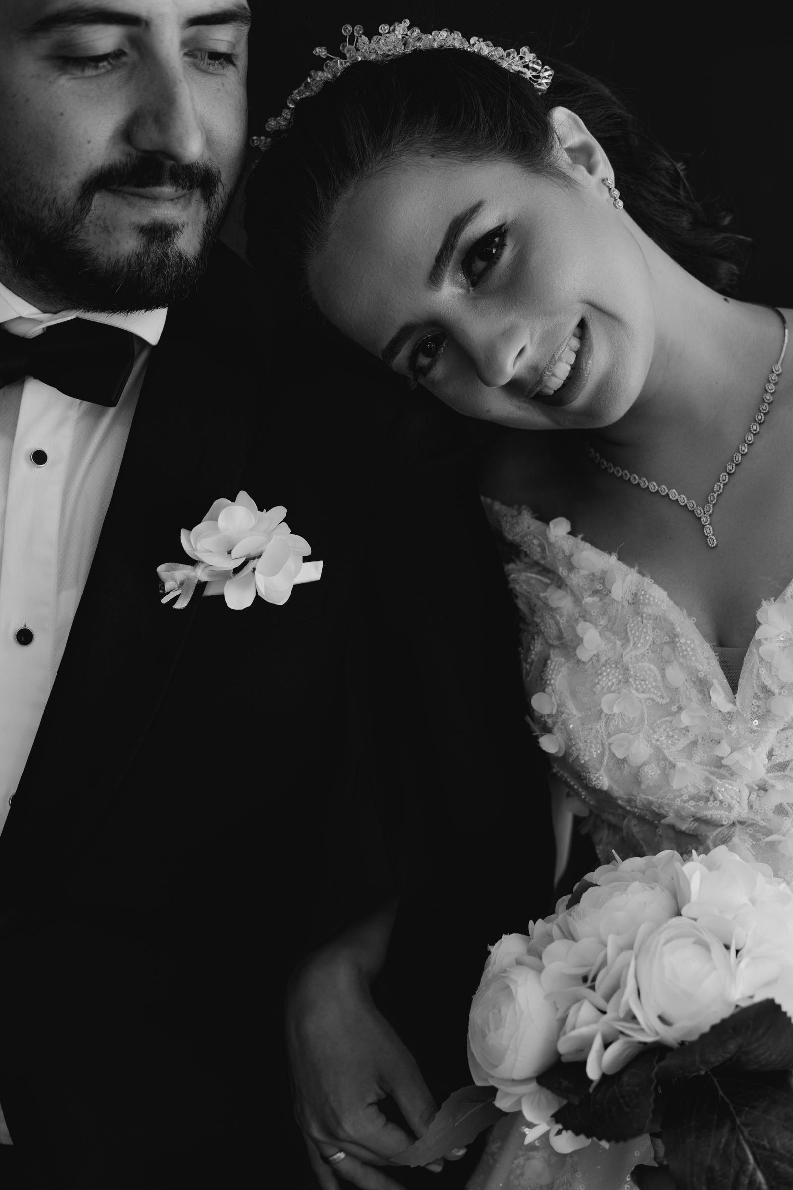 A bride laughing with her groom