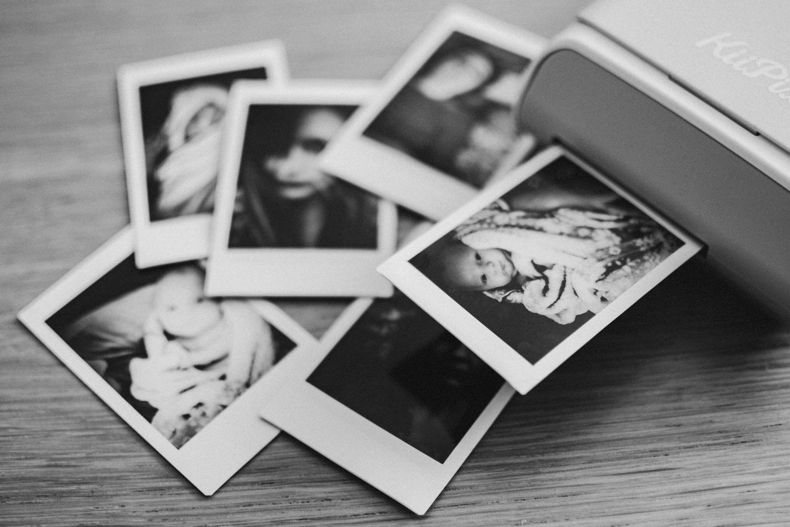 Instant photo prints scattered on a table