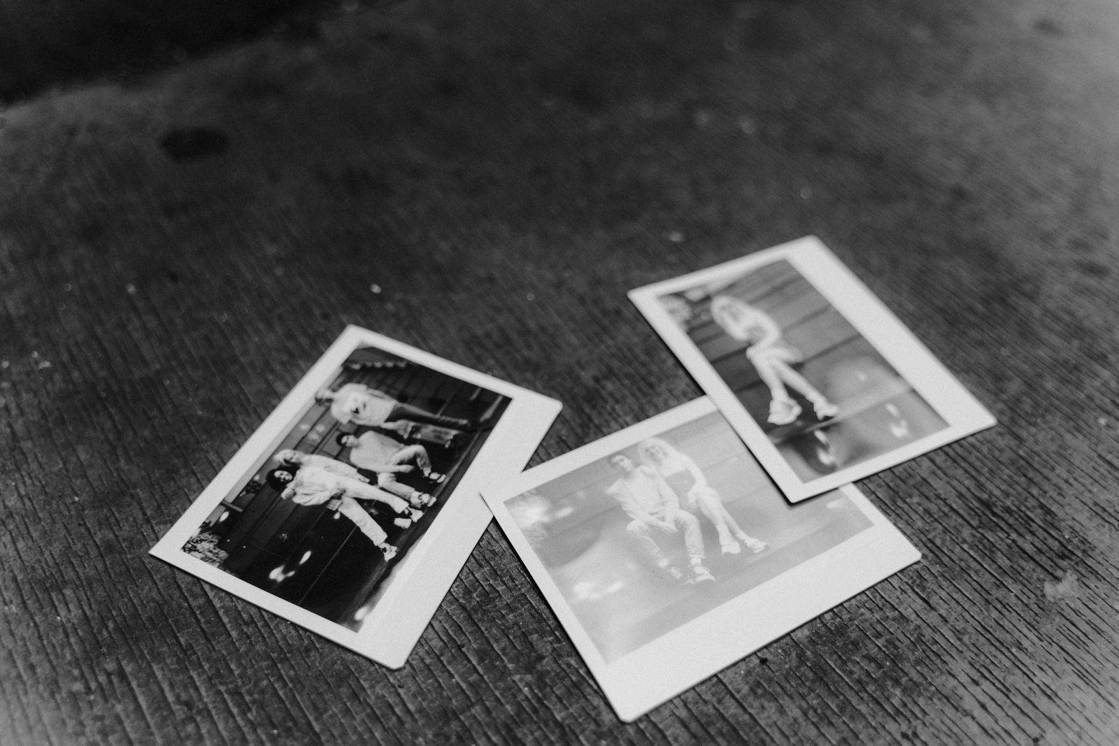 Black-and-white photo prints laid out on a dark surface