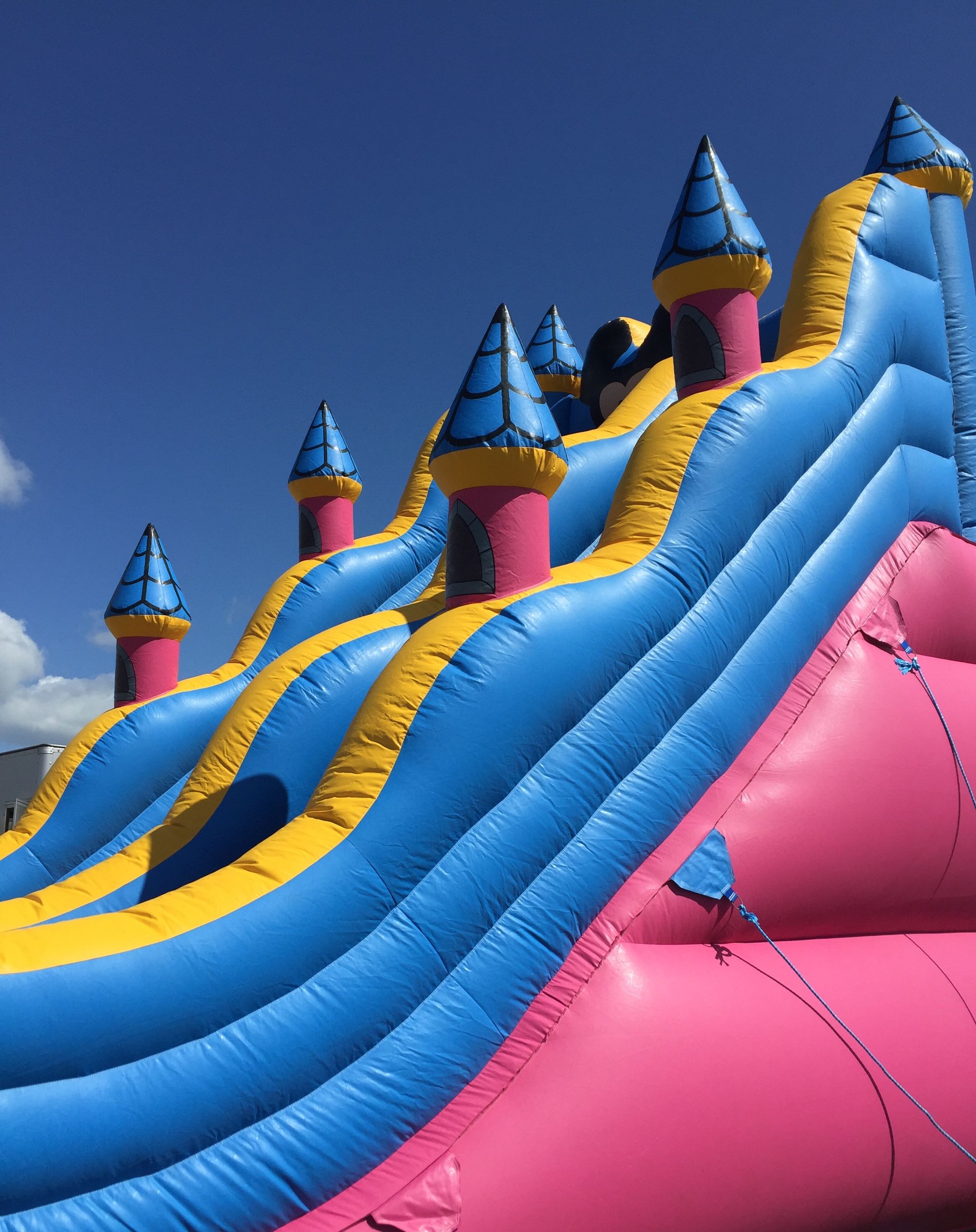 A tall inflatable water slide against the sky