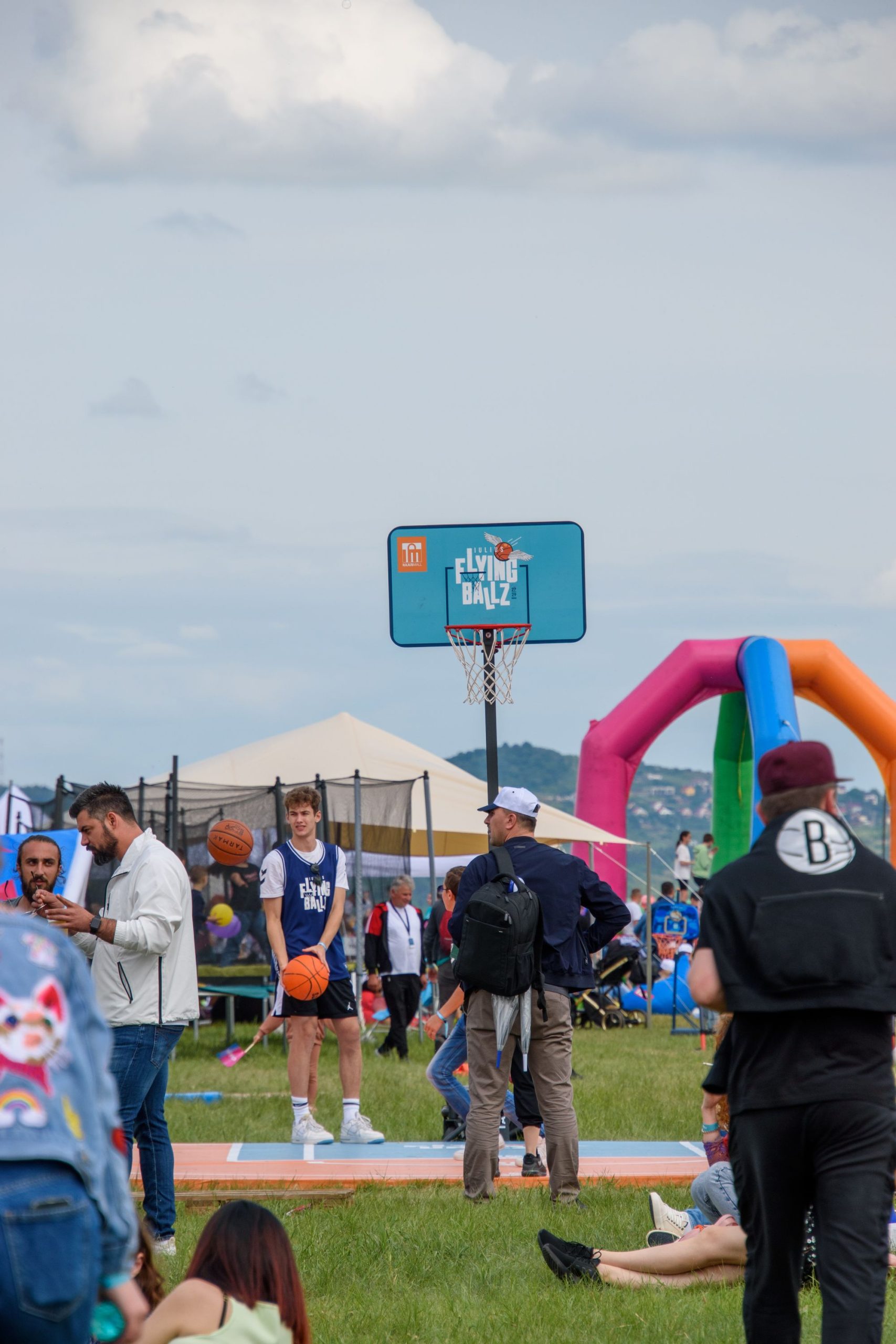 An inflatable basketball hoop game at an outdoor event