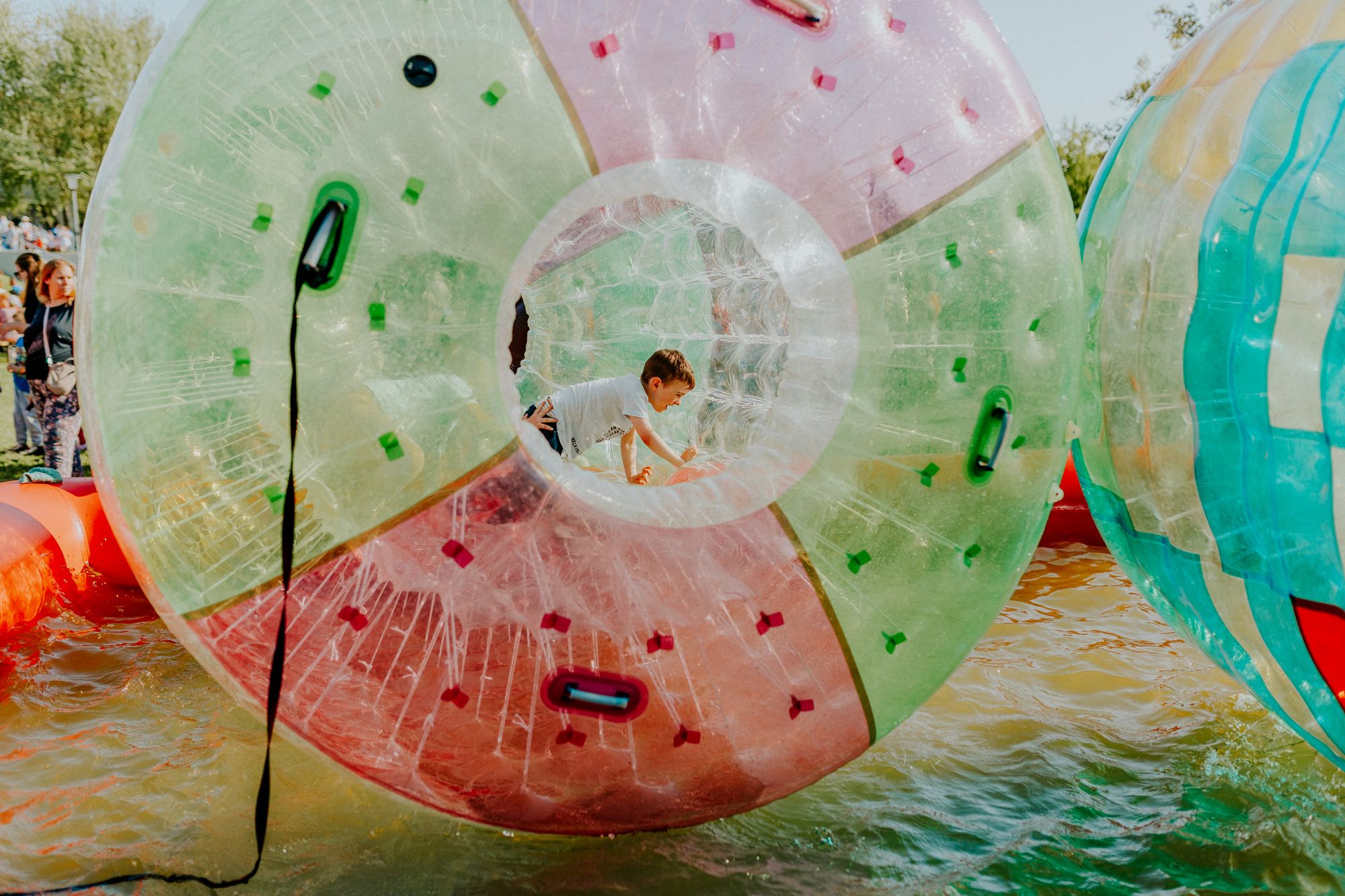A child rolling in a giant clear inflatable ball