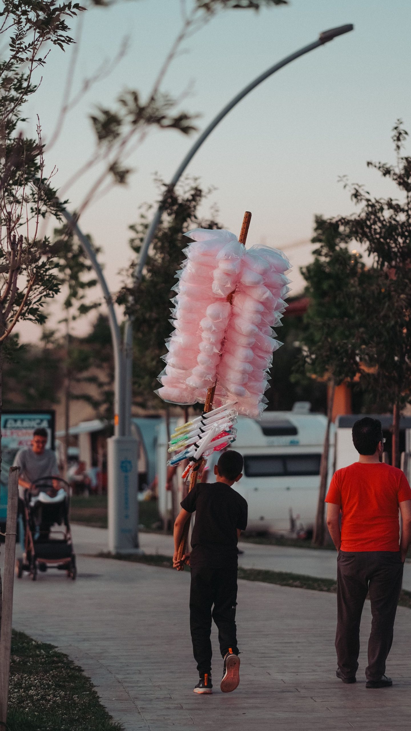 Pink cotton candy bags hanging at a fair stand