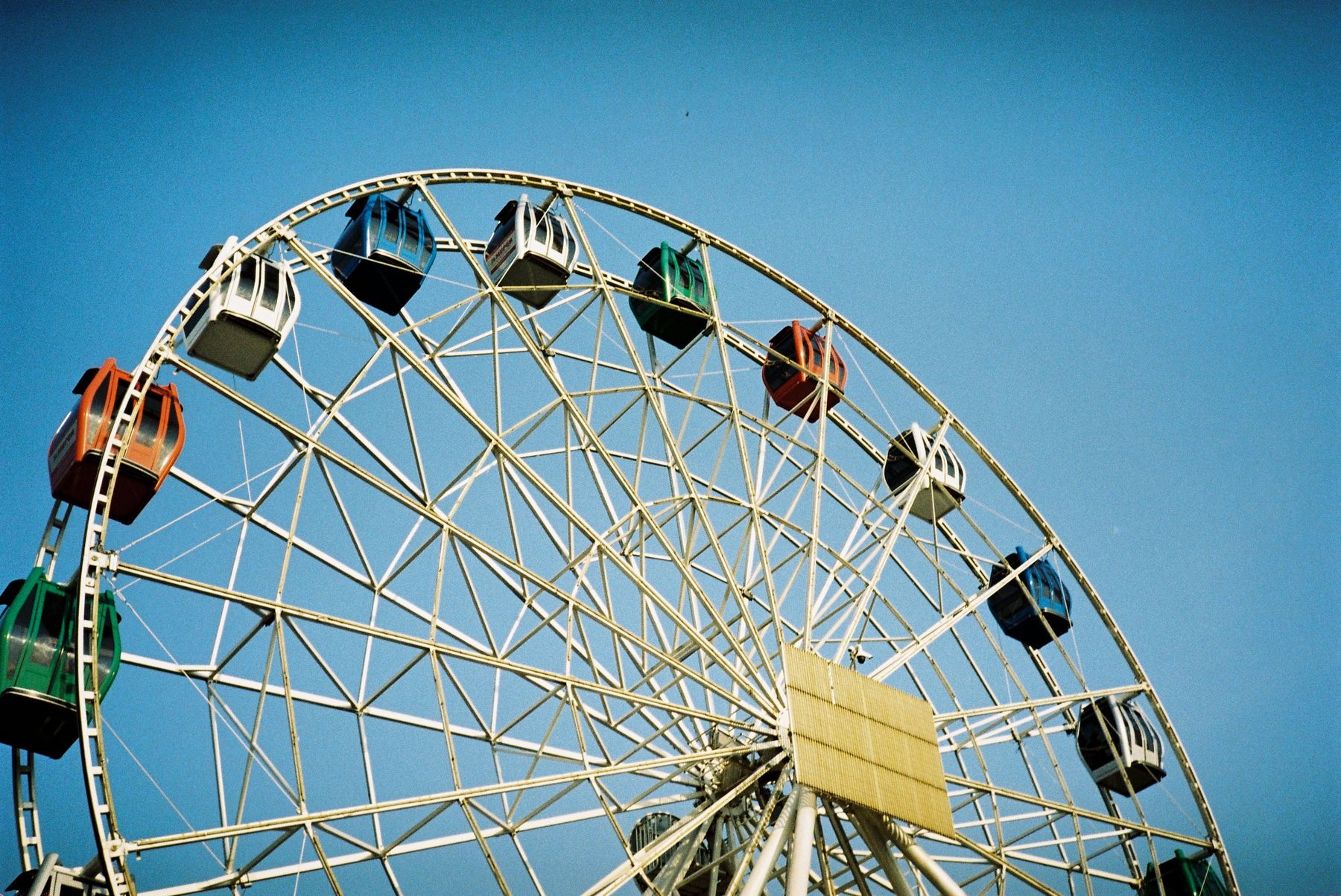 A Ferris wheel against a bright blue sky
