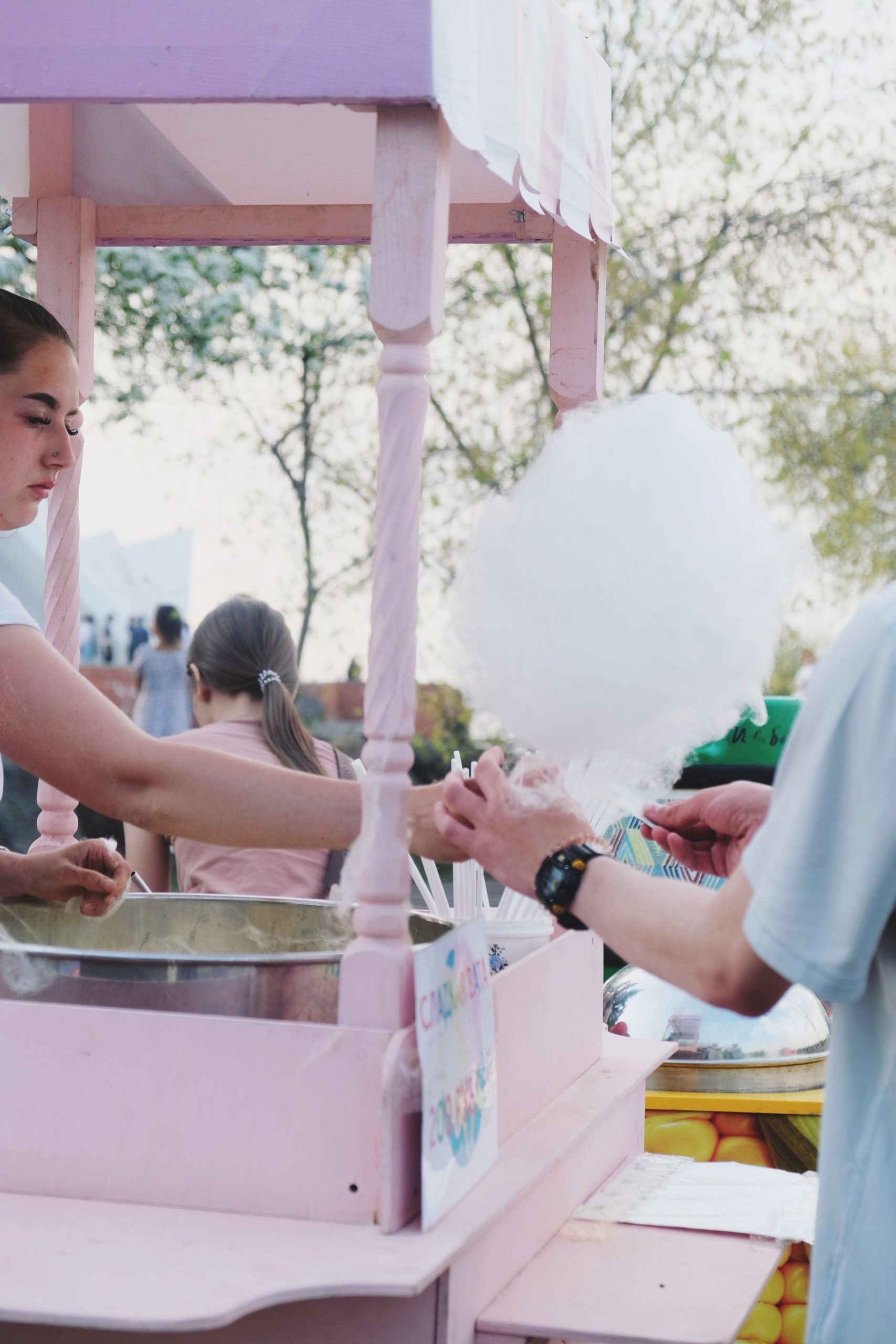Fresh cotton candy being handed to a guest