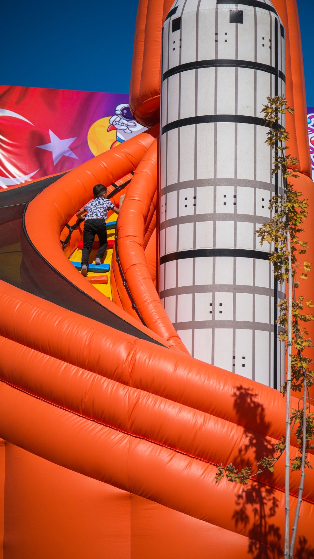 An orange inflatable combo with a climbing wall