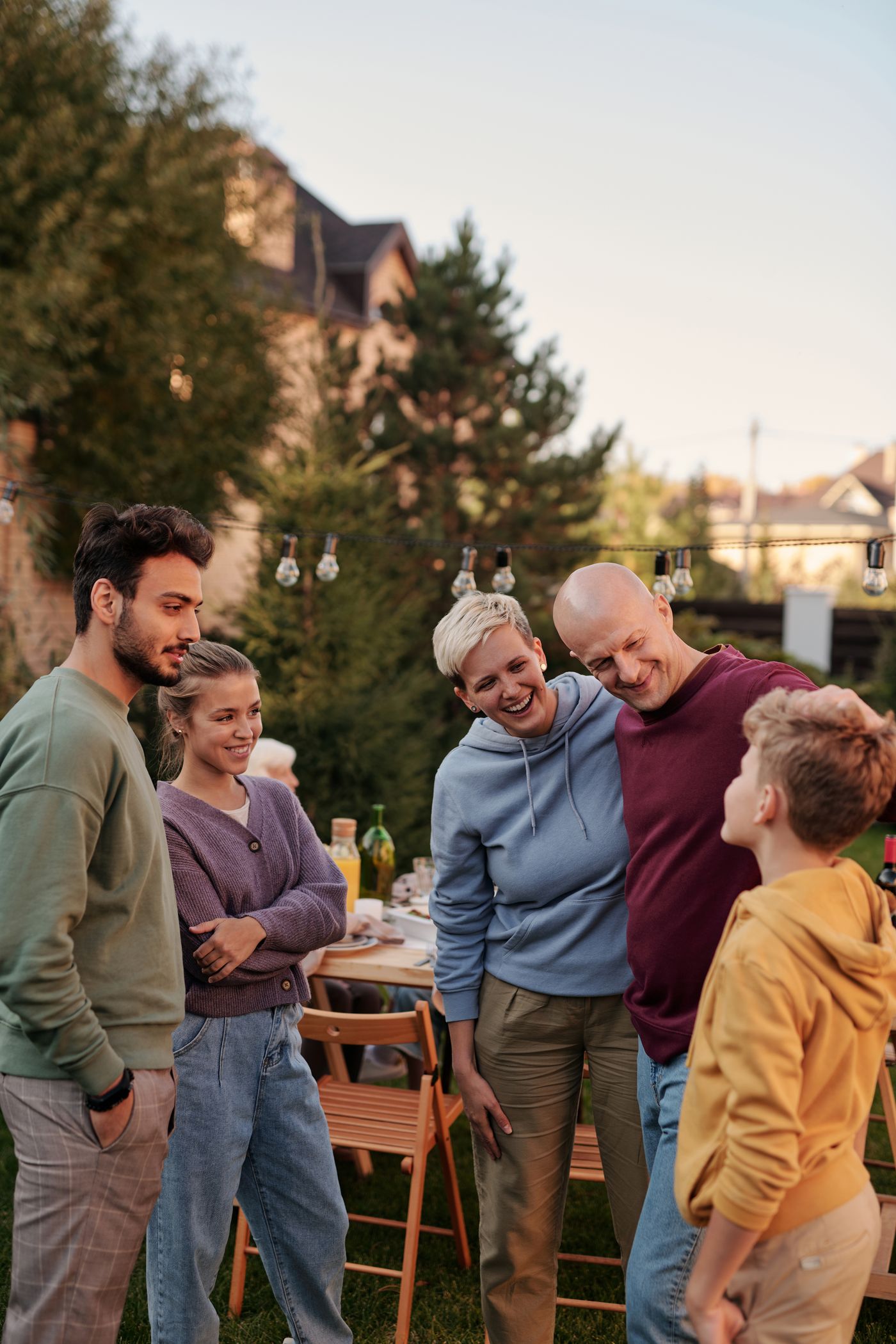 Adults laughing together at an outdoor gathering