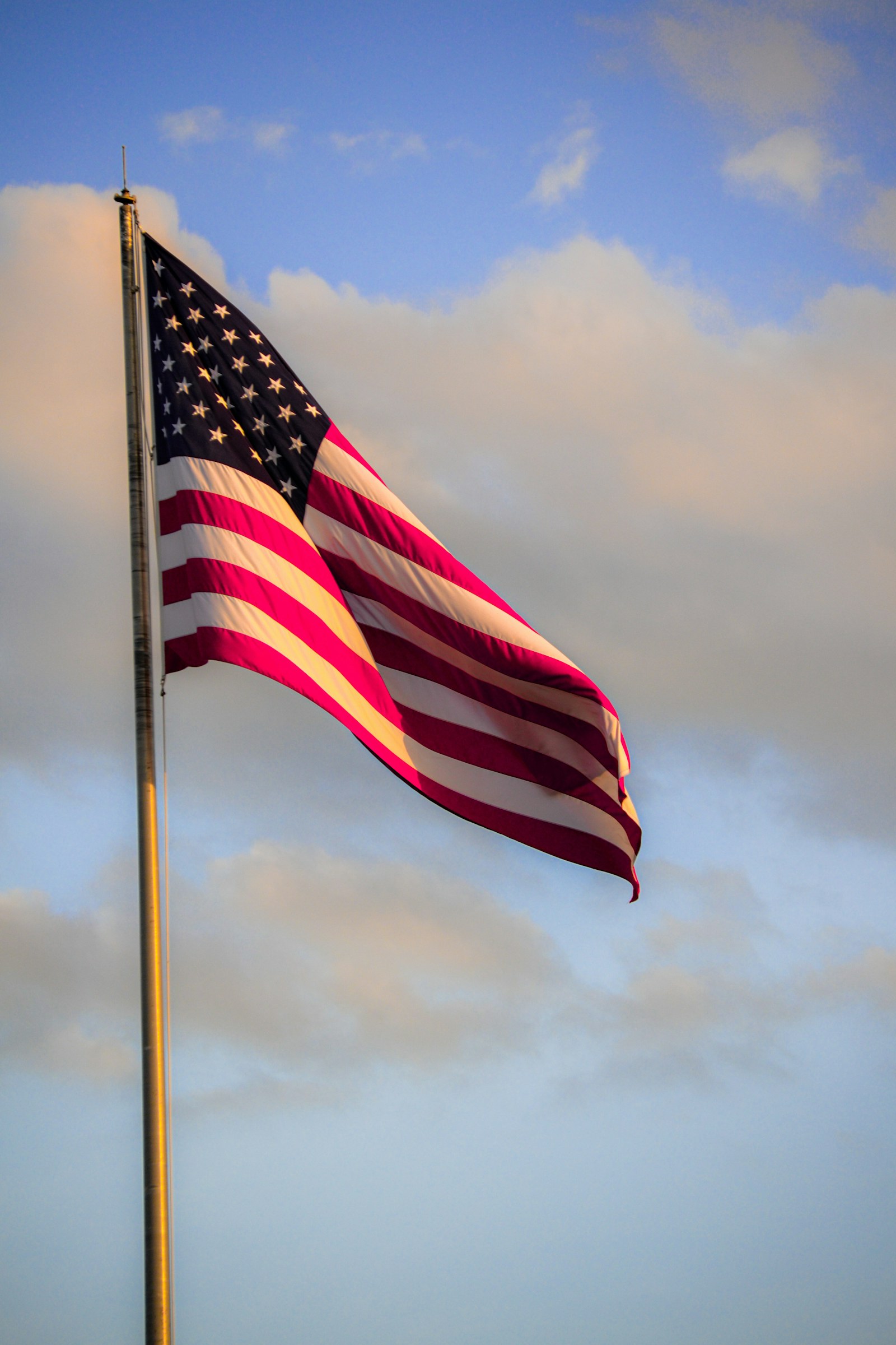 An American flag on a flagpole against the sky