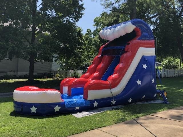 A red, white and blue 15 ft water slide