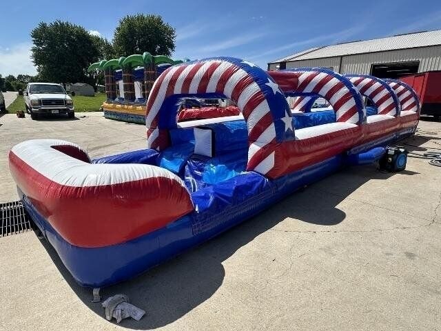 A red, white and blue inflatable slip and slide