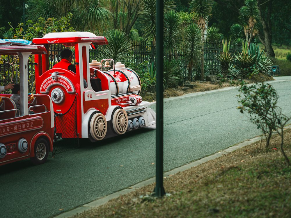 Red trackless train with colorful passenger cars