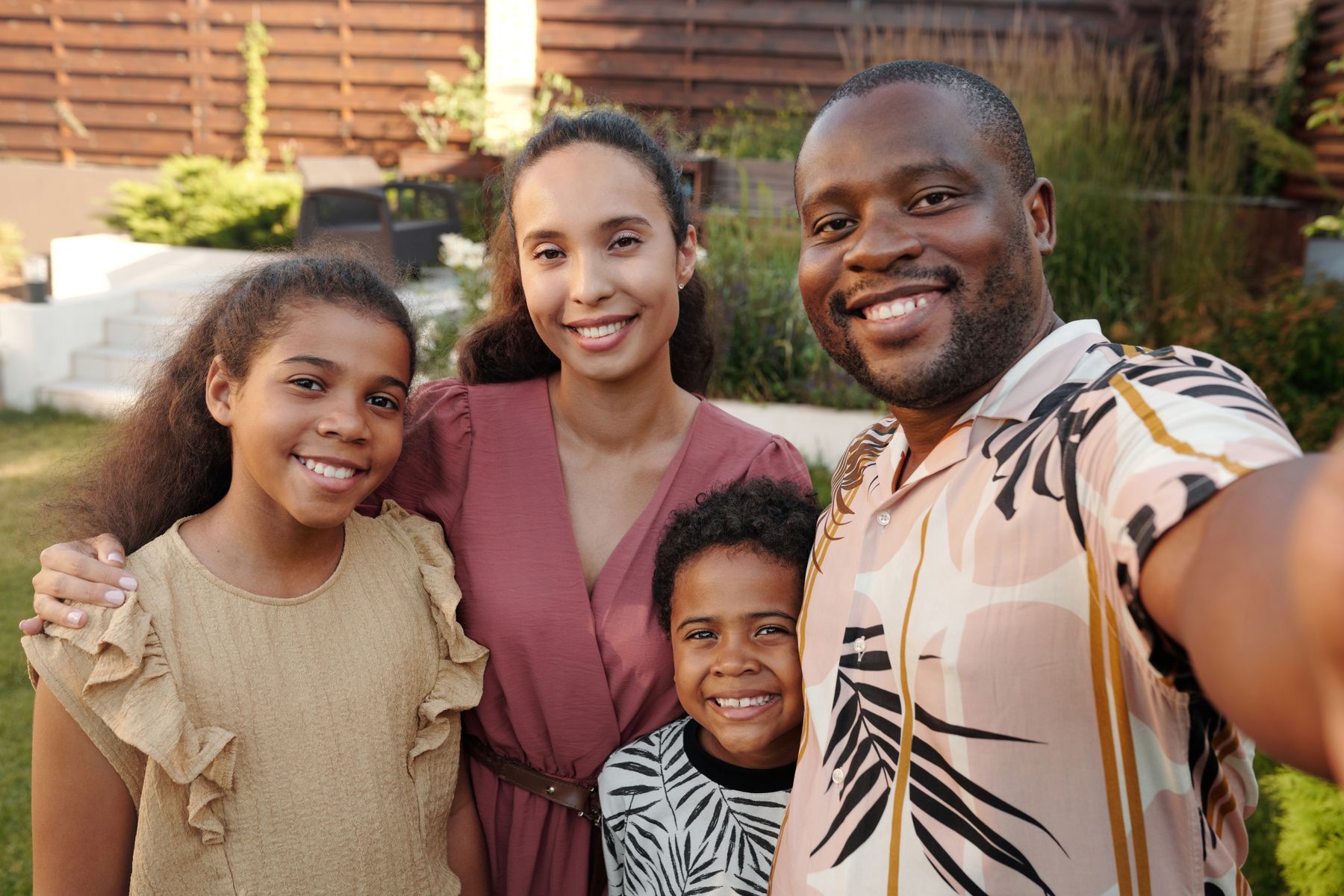 The owners and their kids smiling together outside their home