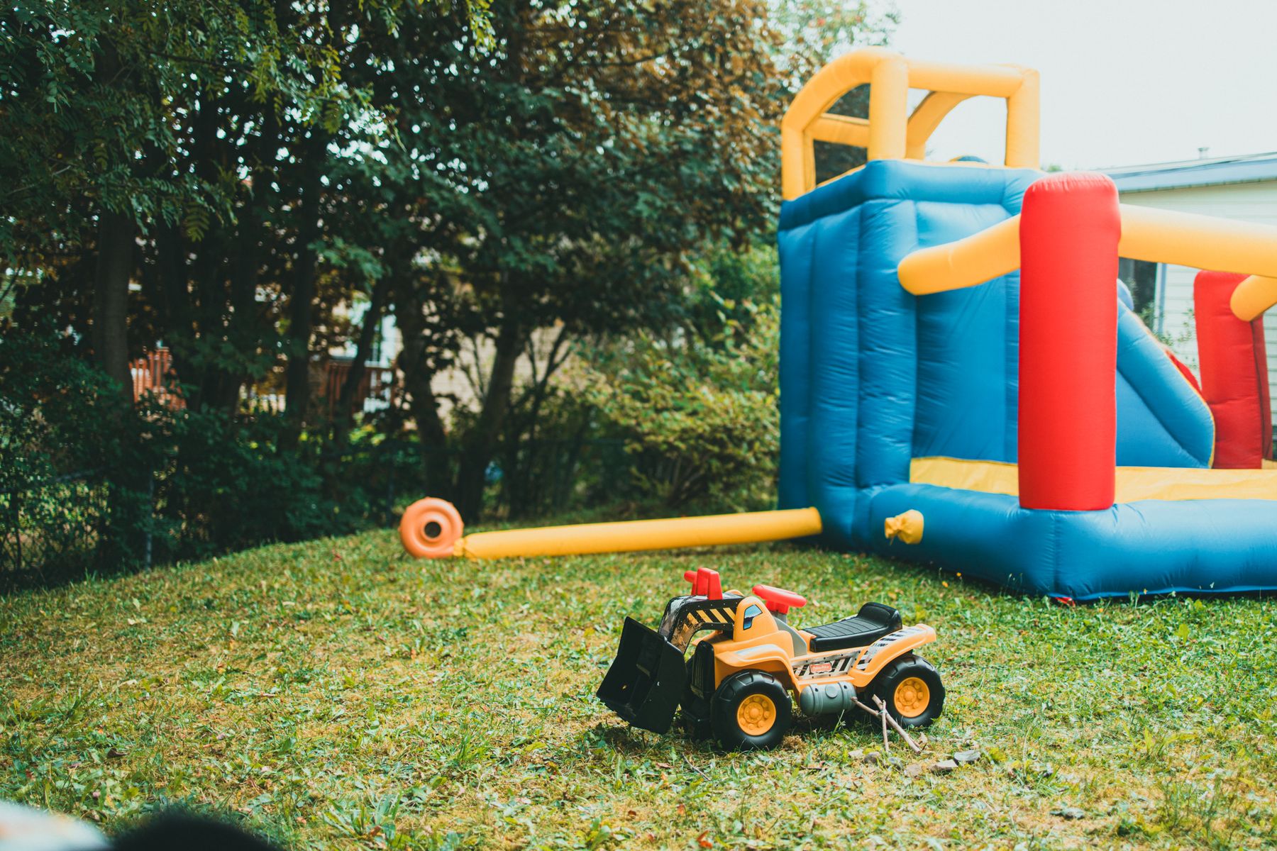 A bounce house and slide combo set up on a lawn