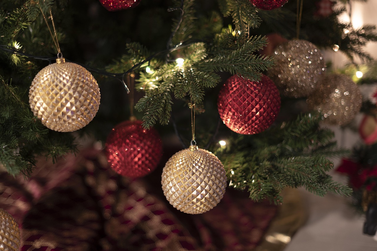 Red and gold ornaments on an evergreen tree