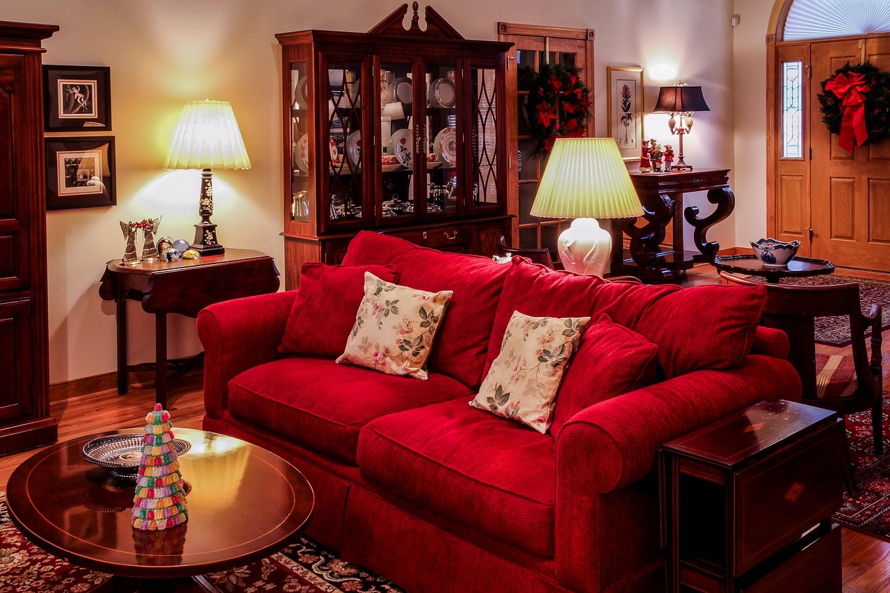 A classic living room with a red sofa decorated for Christmas